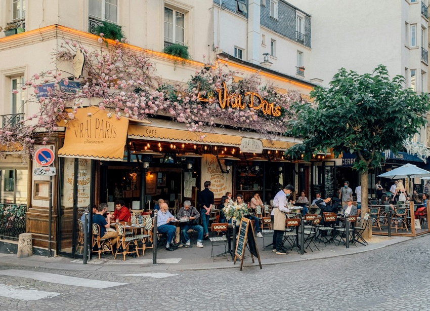 International travelers meet at French cafe
